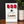 Countdown sign with red number tiles and a blue star, placed on a dark surface with a plant in the background.