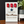 Decorative sign with red tags and a star, counting days until a marine returns home, on a wooden surface.