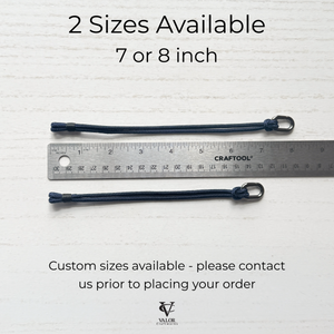 Two navy blue cords with a ruler showing measurements on a light gray background.