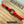 Closeup image of red paracord bracelet on Kraft colored card with Marines text