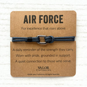 Bracelet with 'Air Force' card on a wooden surface
