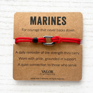 Red bracelet on a brown card with 'MARINES' text and Valor Craftworks branding.