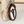 Wooden ornament with medical symbol and text on a white surface with a wooden background