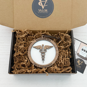Wooden ornament with 'Healthcare Hero' and 'Care & Compassion' text in a Valor Craftworks box.
