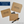 Kraft paper envelopes with flat cards on a white background, featuring text and a pen.