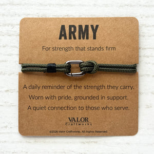 Army bracelet with card on a wooden surface