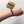 Hand wearing a bracelet with an 'Army' branded card in the background