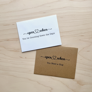White and kraft Open When Card envelopes