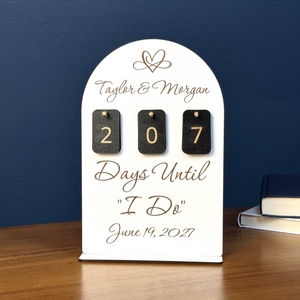 White personalized wedding countdown sign with black number tiles and engraved couple name and date